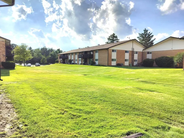a front view of house with yard and ocean view