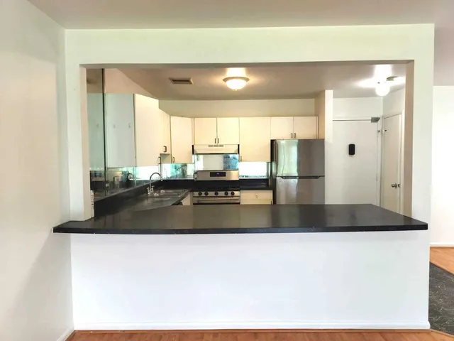 a kitchen with a sink and a refrigerator