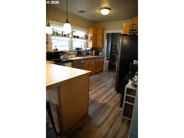 a kitchen with refrigerator and sink