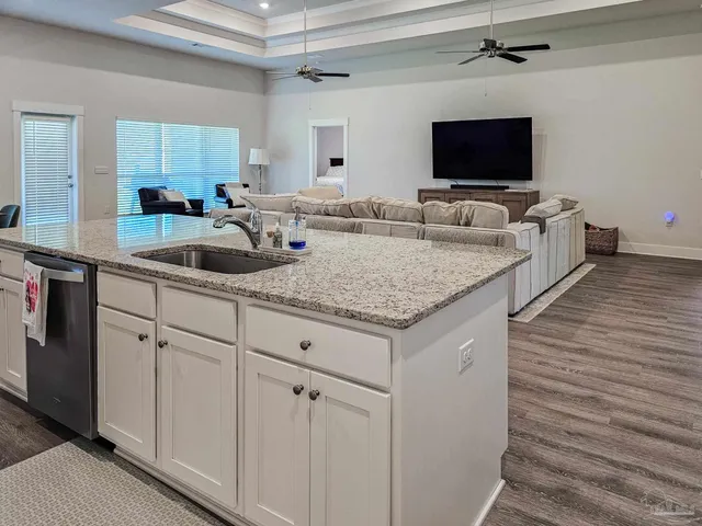 a kitchen with sink and mirror