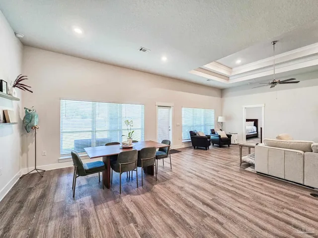 a living room with furniture a wooden floor and a window