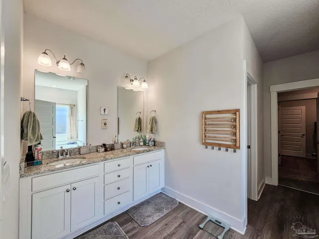 a spacious bathroom with a double vanity sink a mirror and a shower