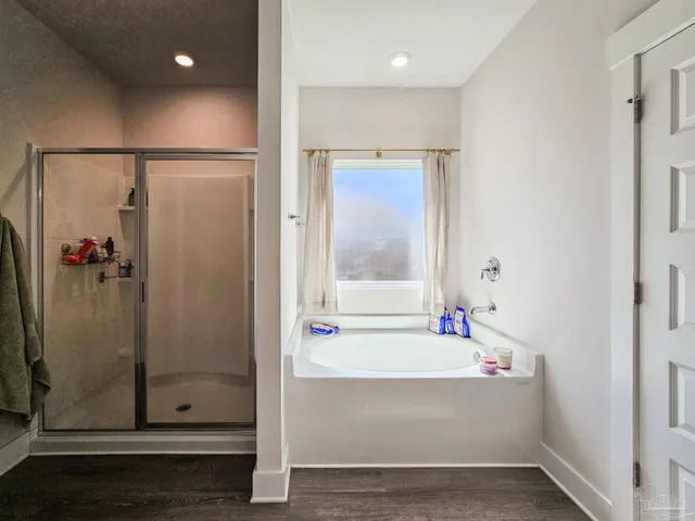 a bathroom with a tub and shower