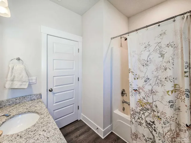 a bathroom with a shower and a sink