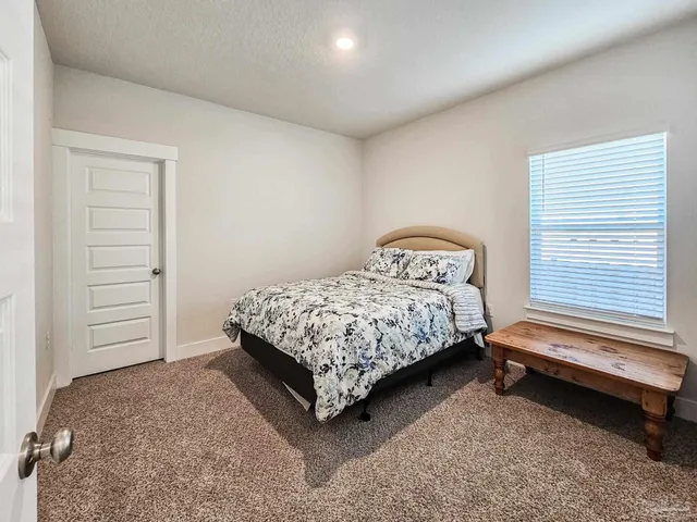 a bedroom with a bed and dresser