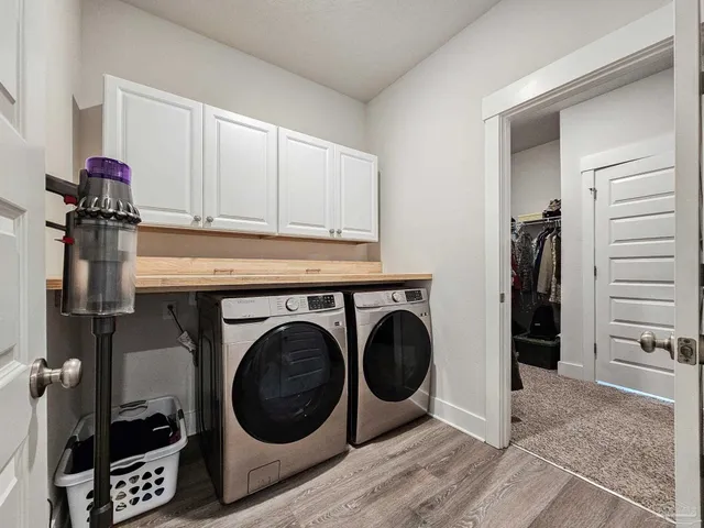 a utility room with sink dryer and washer