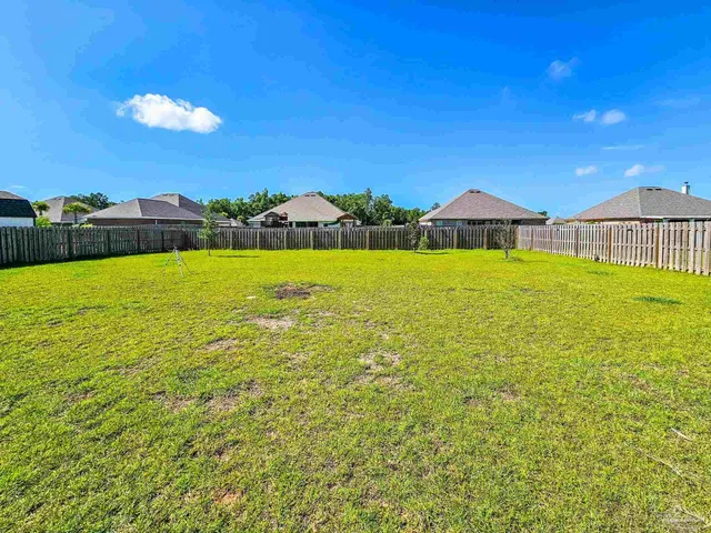 a view of an ocean beach and a yard