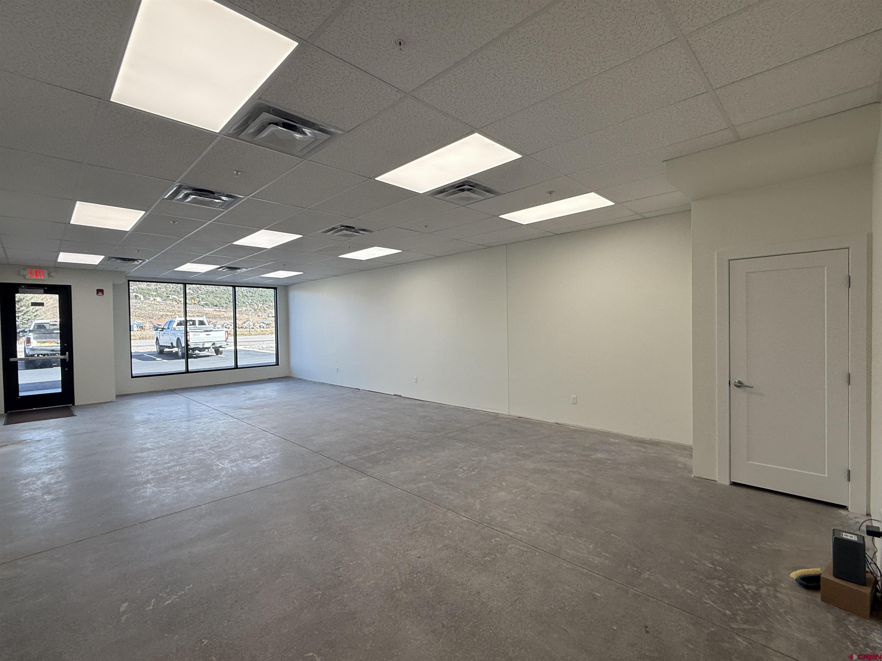 205 Jasper Lane, Unit 103 Ridgway, CO 81432 - Photo 6 of 28 an empty room with windows and ceiling fan