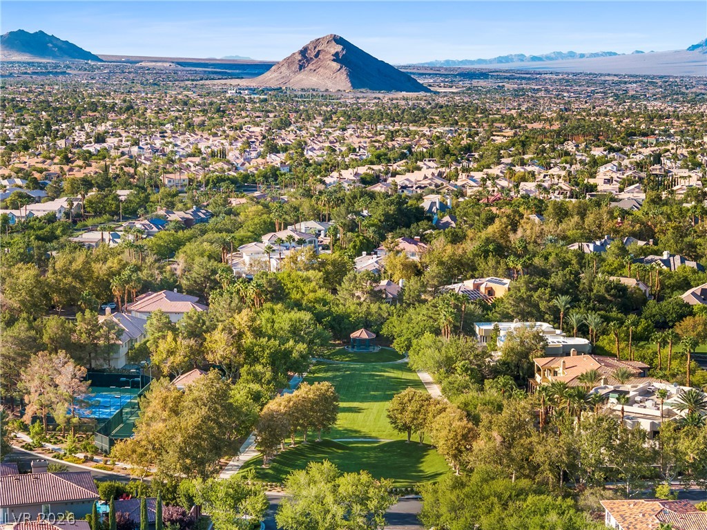 2000 Grouse Street Las Vegas, NV 89134 - Photo 78 of 89 Vast green spaces and mature trees define this residential landscape, set against a majestic mountain backdrop.