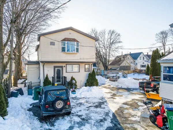 a view of a white house with a yard covered in snow