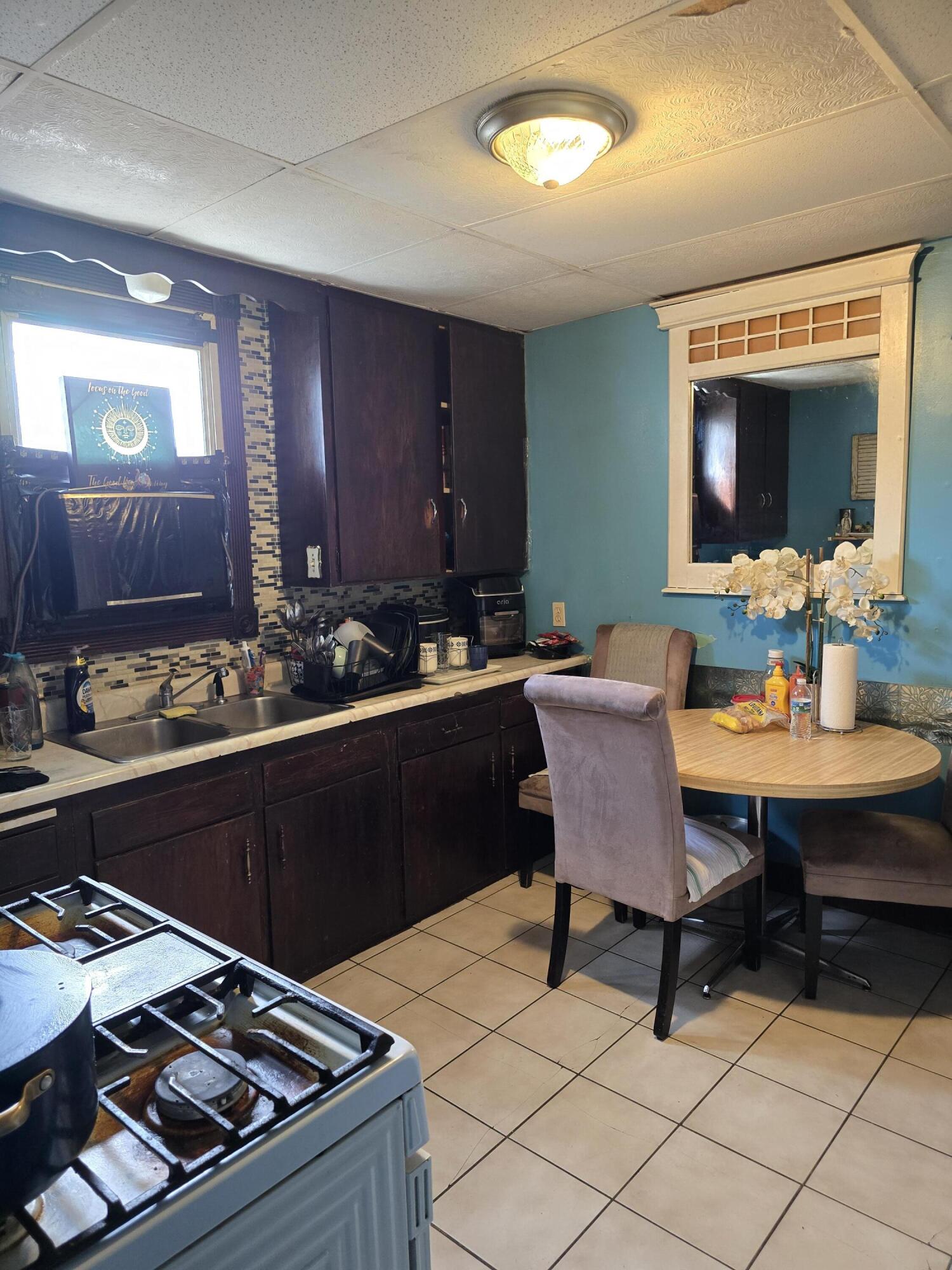 5210 Howard Avenue Hammond, IN 46320 - Photo 17 of 17 a kitchen with a table chairs and a stove