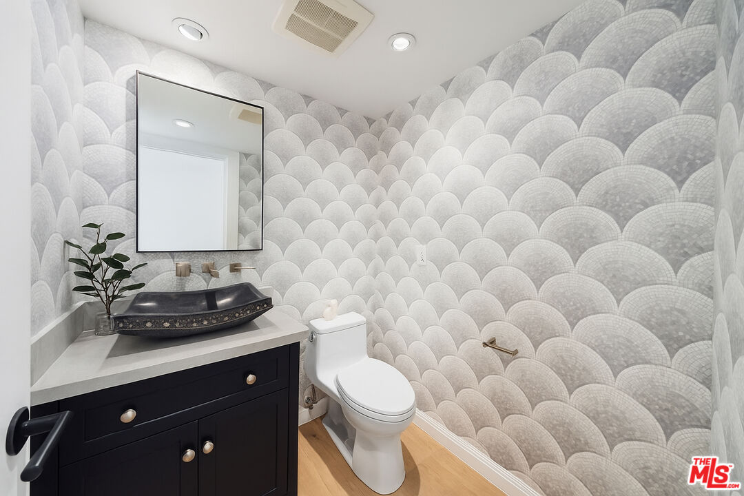 831 14th Street, Unit 2 Santa Monica, CA 90403 - Photo 14 of 32 a bathroom with a sink mirror vanity and toilet