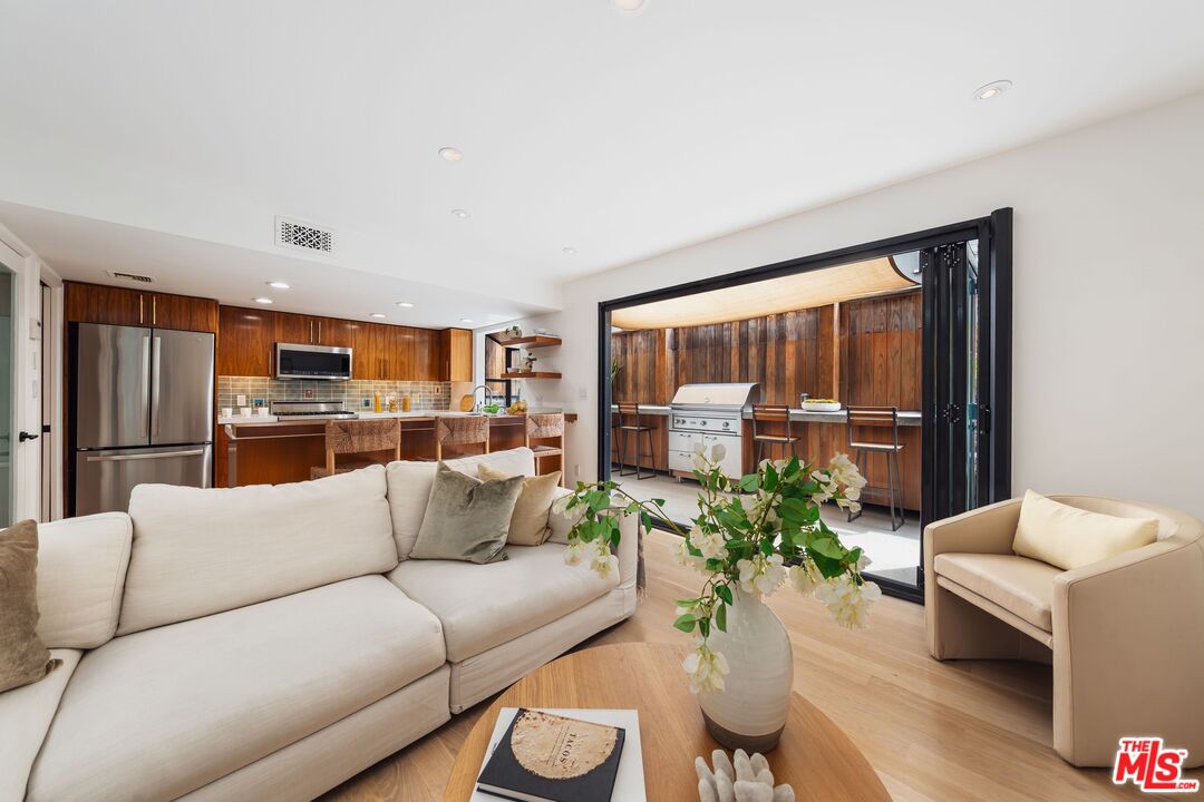 831 14th Street, Unit 2 Santa Monica, CA 90403 - Photo 2 of 32 a living room with furniture and a large window