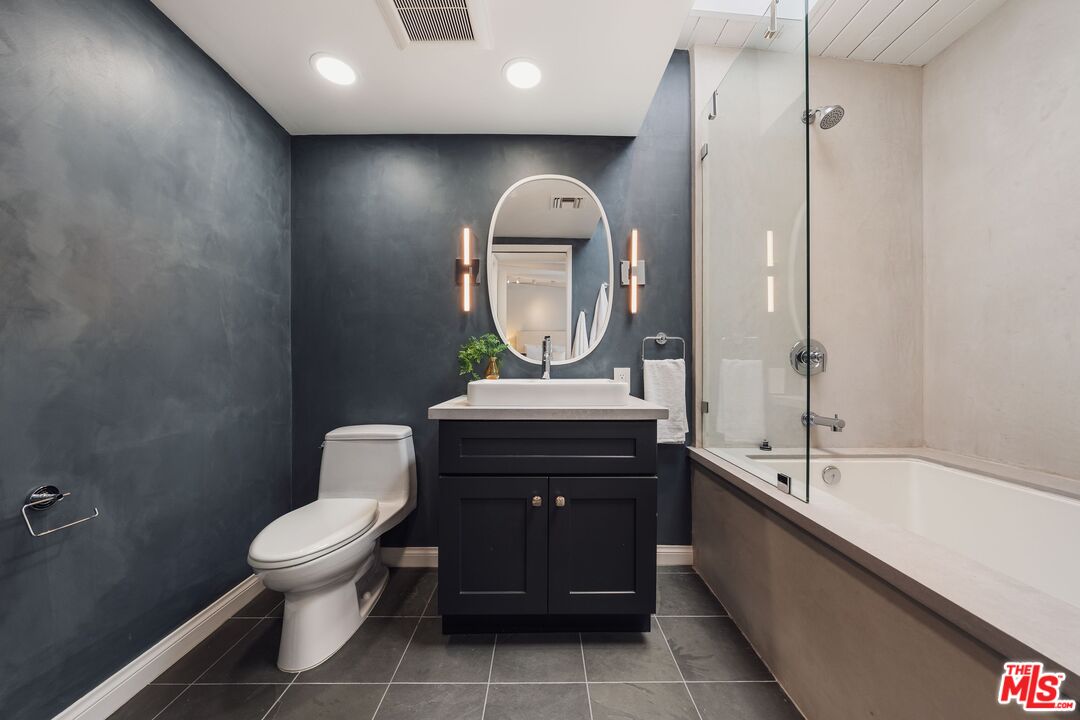 831 14th Street, Unit 2 Santa Monica, CA 90403 - Photo 23 of 32 a bathroom with a toilet sink and mirror