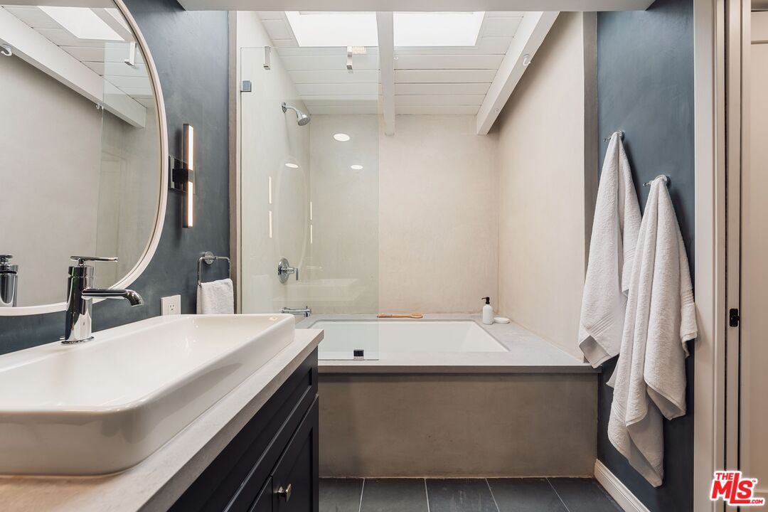831 14th Street, Unit 2 Santa Monica, CA 90403 - Photo 24 of 32 a bathroom with a sink and a large mirror