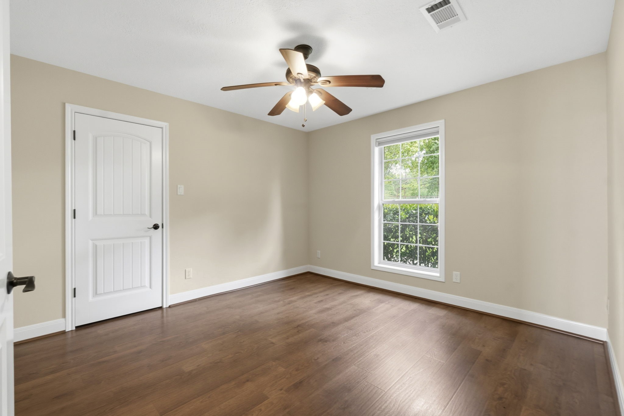 259 Memphis Bell Lane Trinity, TX 75862 - Photo 20 of 50 an empty room with wooden floor chandelier fan and windows