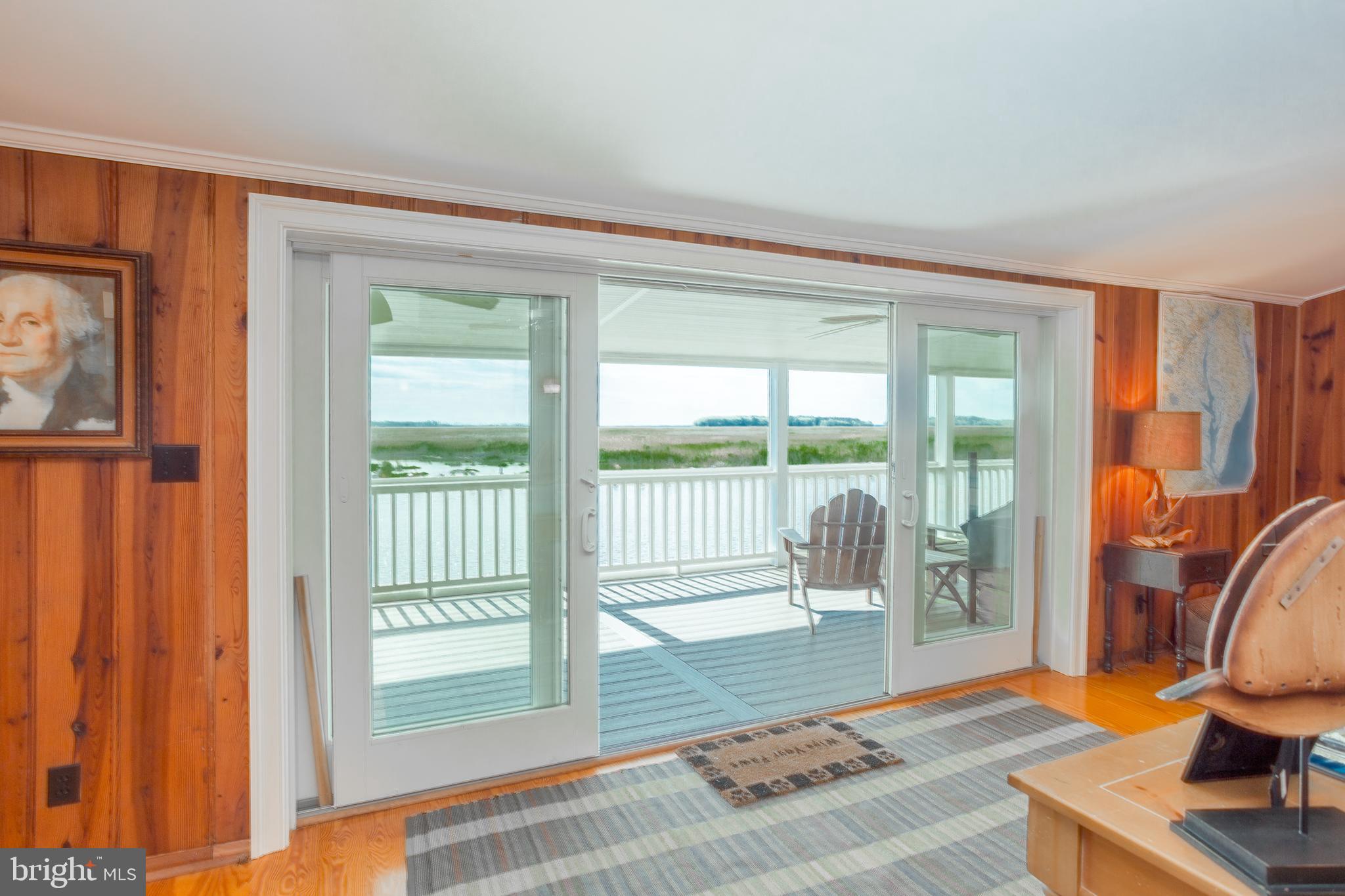 3706 Bestpitch Ferry Road Cambridge, MD 21613 - Photo 11 of 43 a living room with furniture and a floor to ceiling window