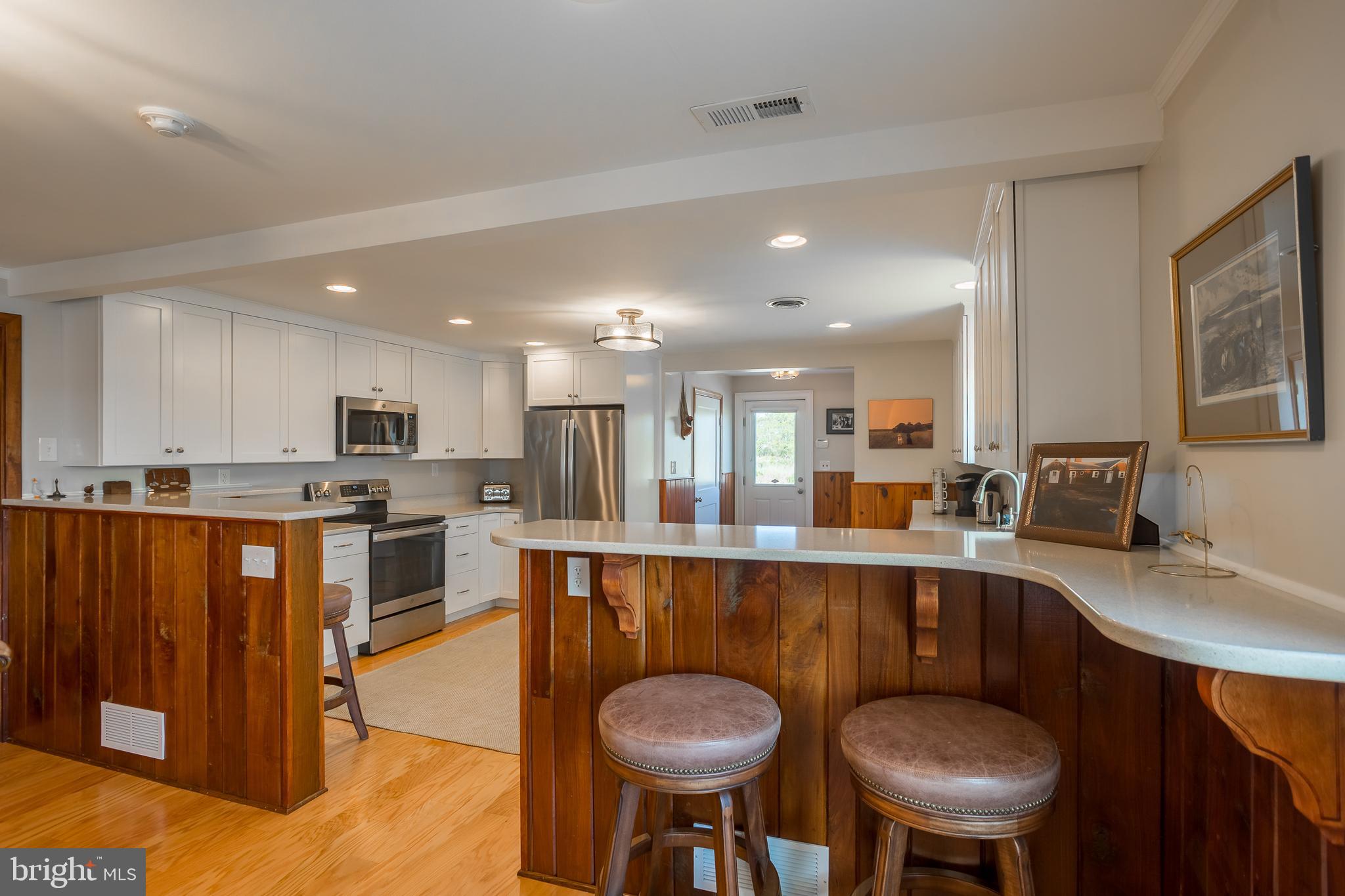 3706 Bestpitch Ferry Road Cambridge, MD 21613 - Photo 19 of 43 a large kitchen with a table and chairs