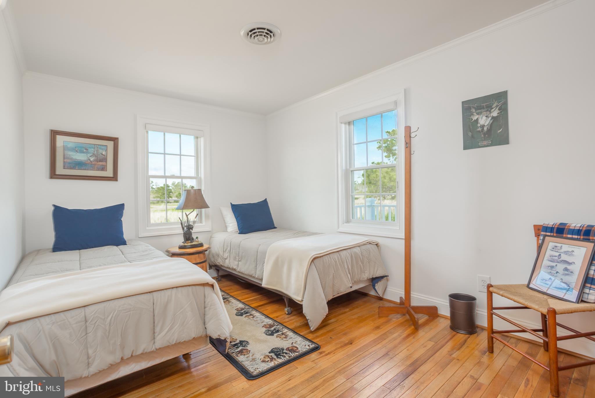 3706 Bestpitch Ferry Road Cambridge, MD 21613 - Photo 24 of 43 a bedroom with a bed and wooden floor