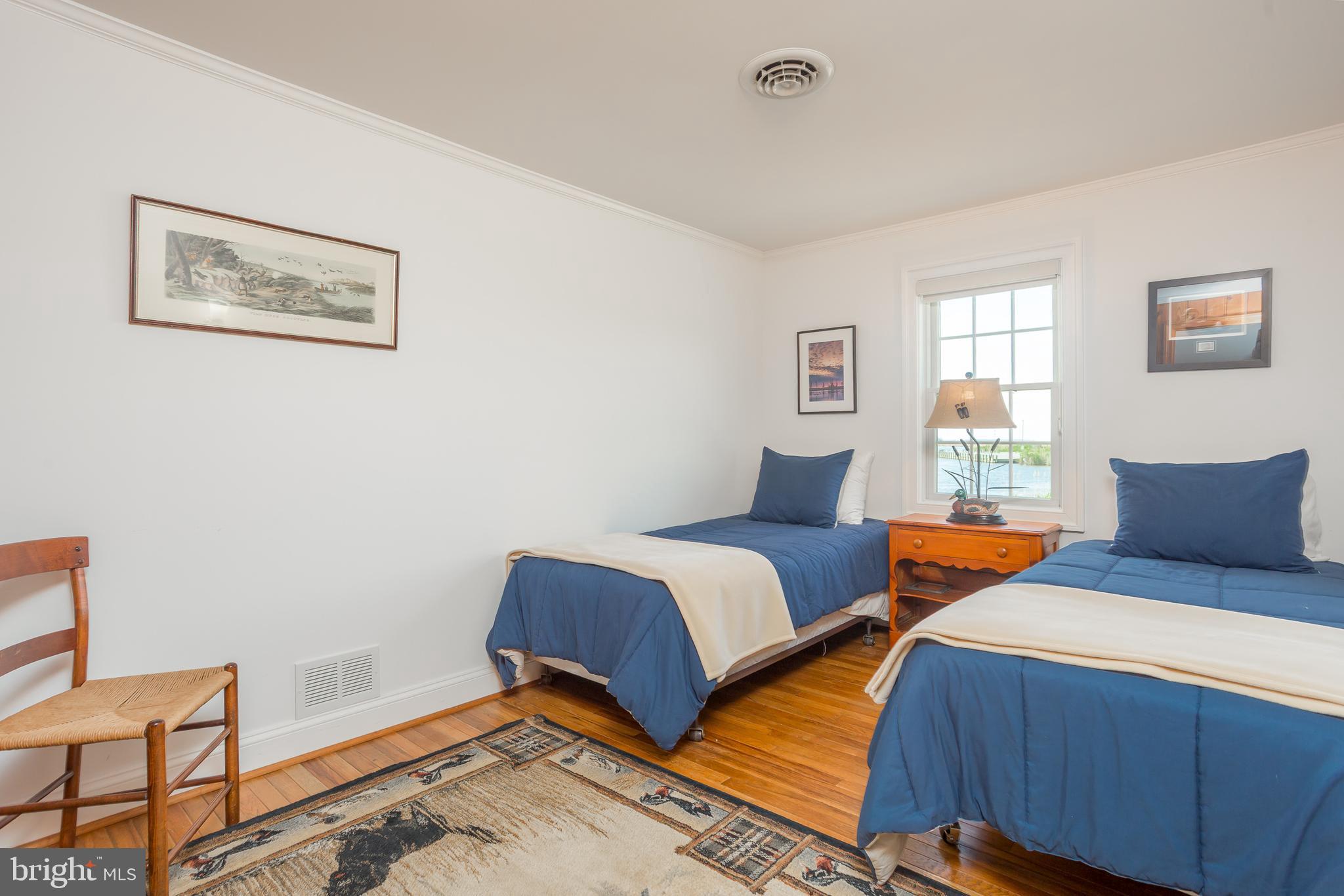 3706 Bestpitch Ferry Road Cambridge, MD 21613 - Photo 25 of 43 a bedroom with two beds and a window