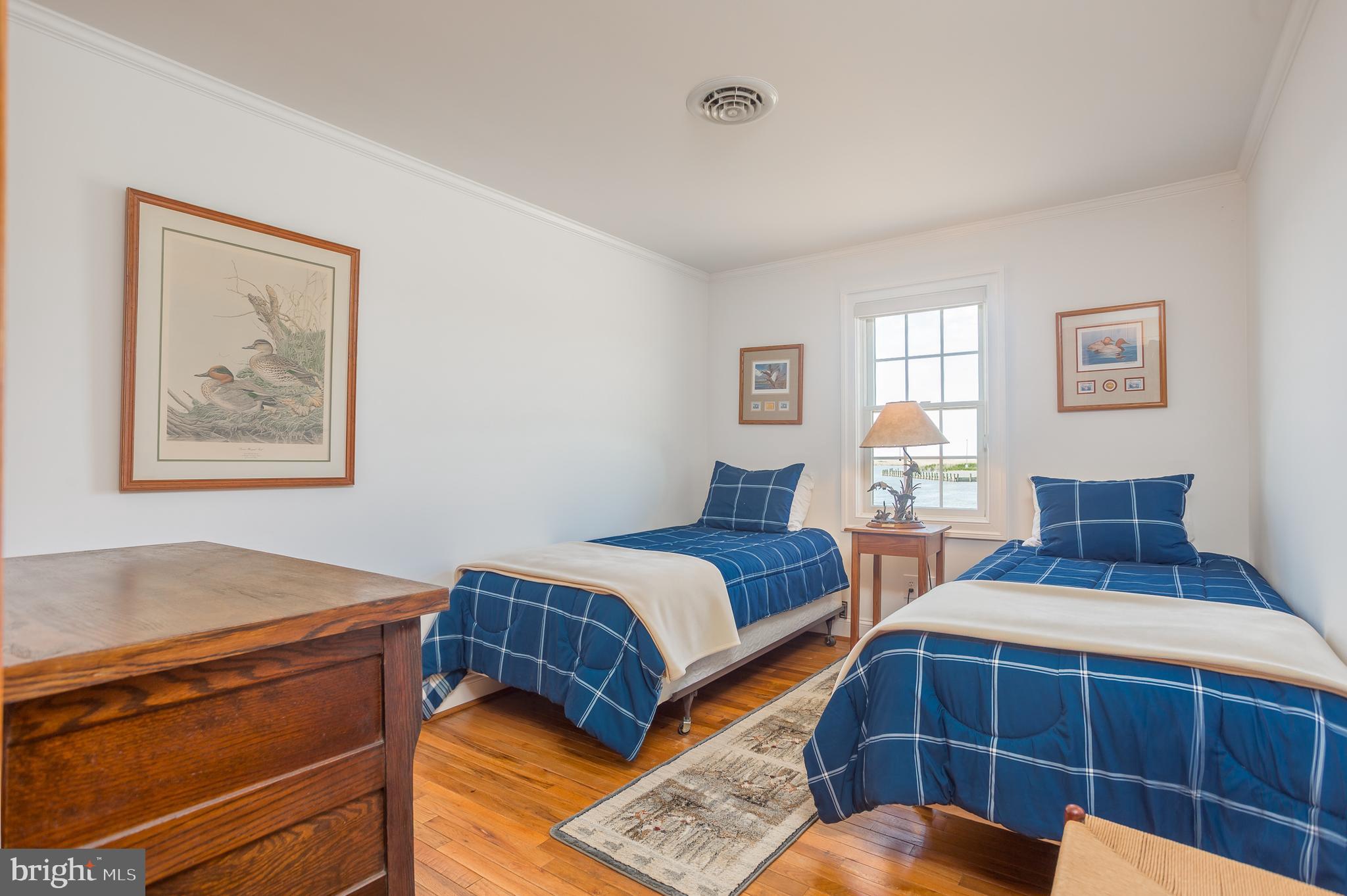 3706 Bestpitch Ferry Road Cambridge, MD 21613 - Photo 27 of 43 a bedroom with bed and a window