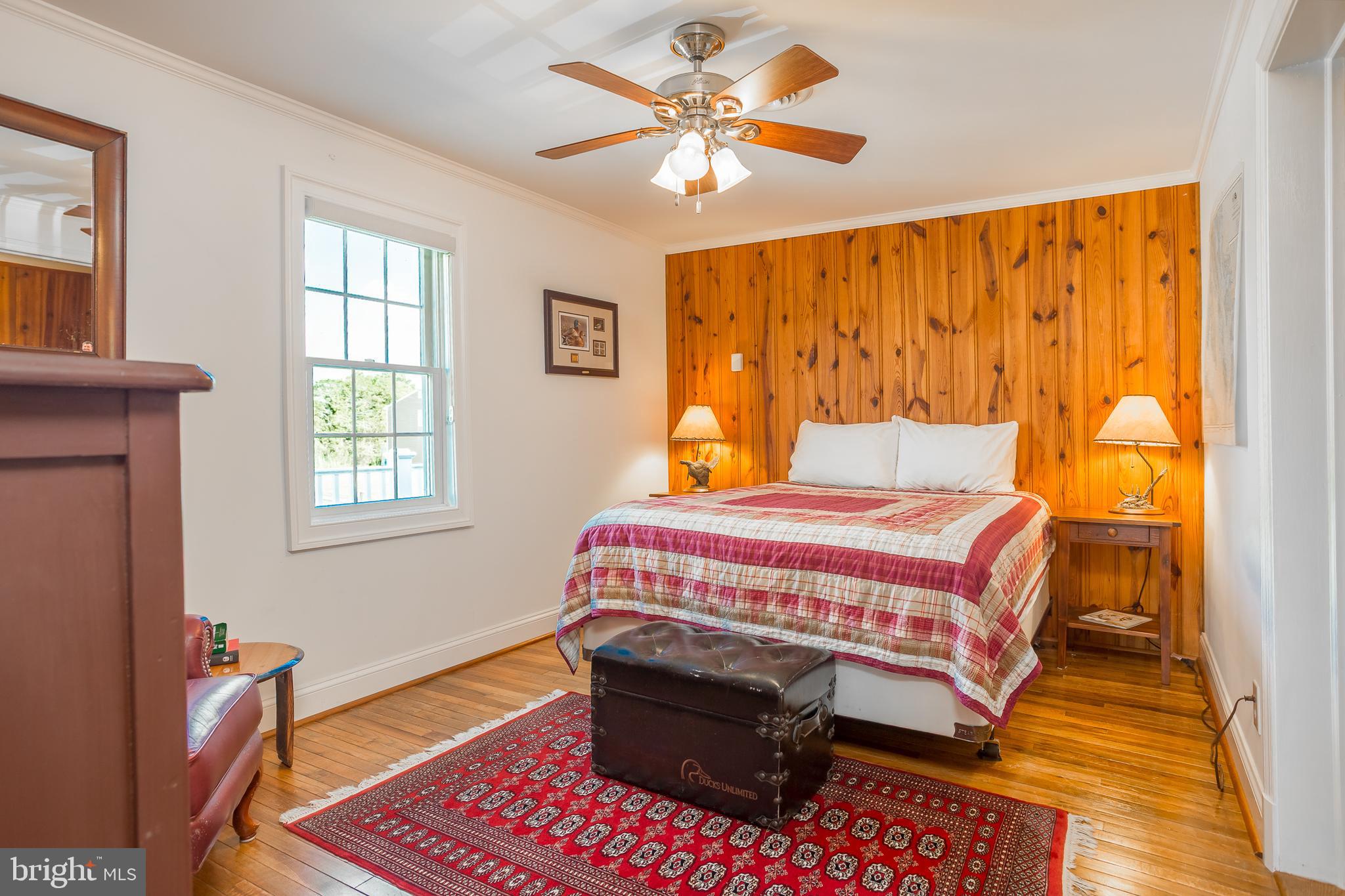 3706 Bestpitch Ferry Road Cambridge, MD 21613 - Photo 29 of 43 a bedroom with a bed and a chandelier