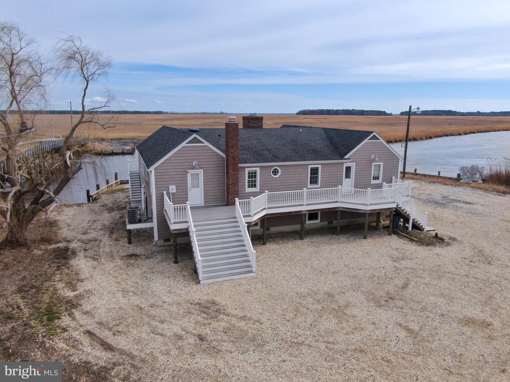 3706 Bestpitch Ferry Road Cambridge, MD 21613 - Photo 3 of 43 an aerial view of a house with a yard and mountain view