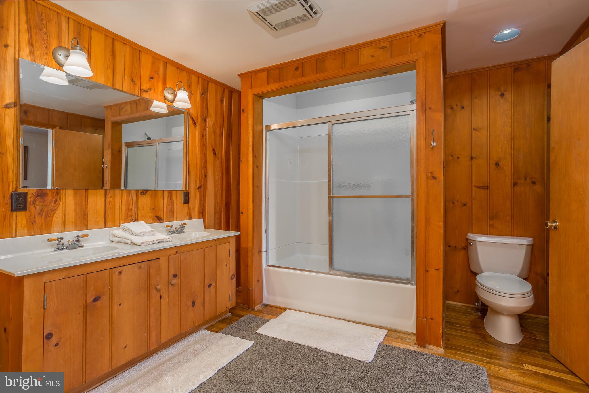 3706 Bestpitch Ferry Road Cambridge, MD 21613 - Photo 31 of 43 a spacious bathroom with a granite countertop sink a toilet and shower