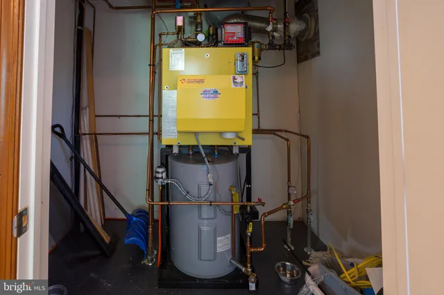 a room with water heater and stairs