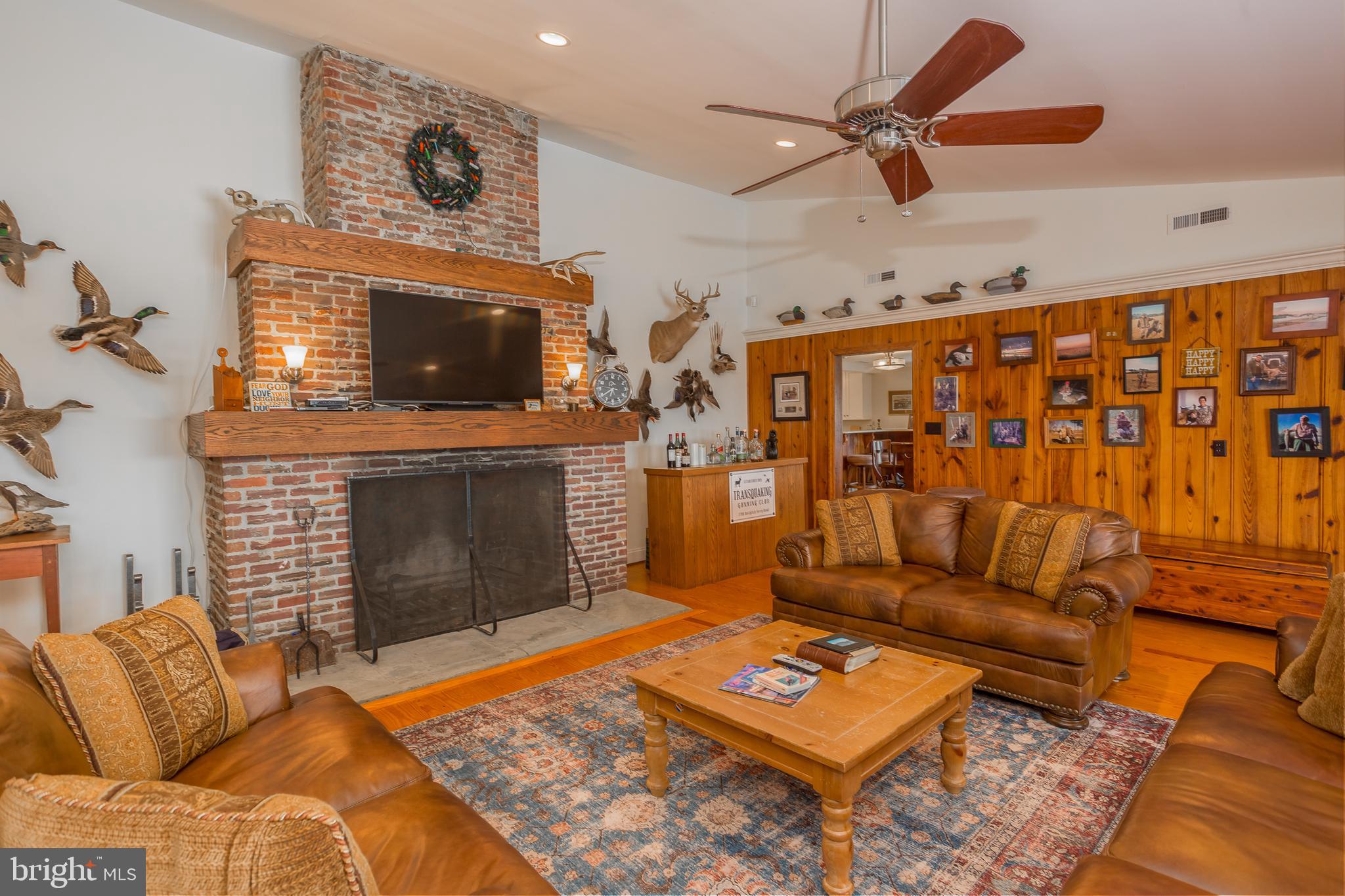3706 Bestpitch Ferry Road Cambridge, MD 21613 - Photo 8 of 43 a living room with furniture a flat screen tv and a fireplace