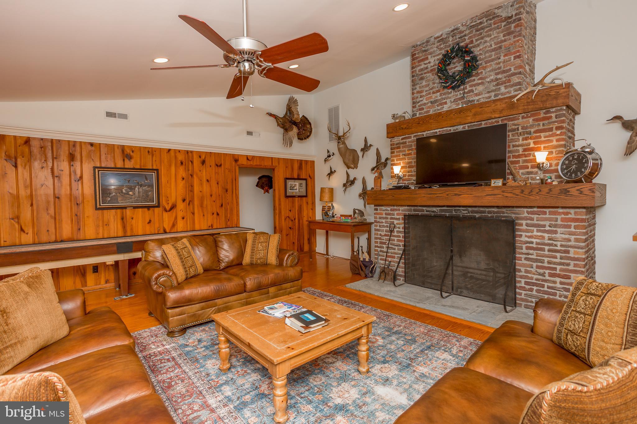 3706 Bestpitch Ferry Road Cambridge, MD 21613 - Photo 10 of 43 a living room with furniture and a fireplace