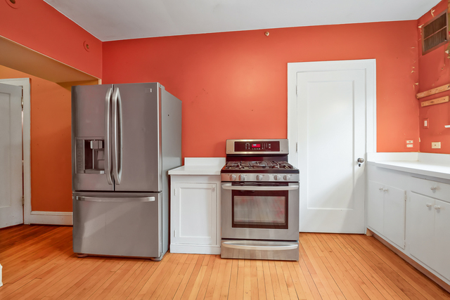 60 Sheridan Road Highland Park, IL 60035 - Photo 13 of 29 a kitchen with stainless steel appliances granite countertop a refrigerator a stove and a wooden floors