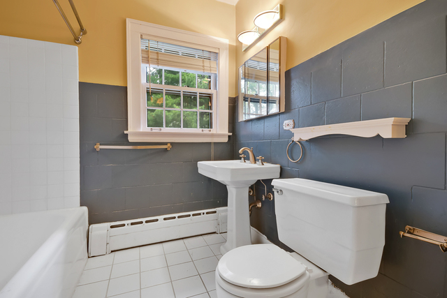 60 Sheridan Road Highland Park, IL 60035 - Photo 16 of 29 a white toilet sitting next to a bathroom sink