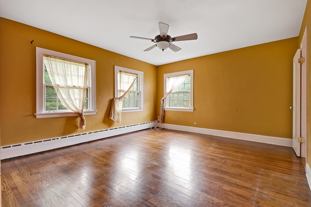 60 Sheridan Road Highland Park, IL 60035 - Photo 18 of 29 a view of an empty room with a window and wooden floor