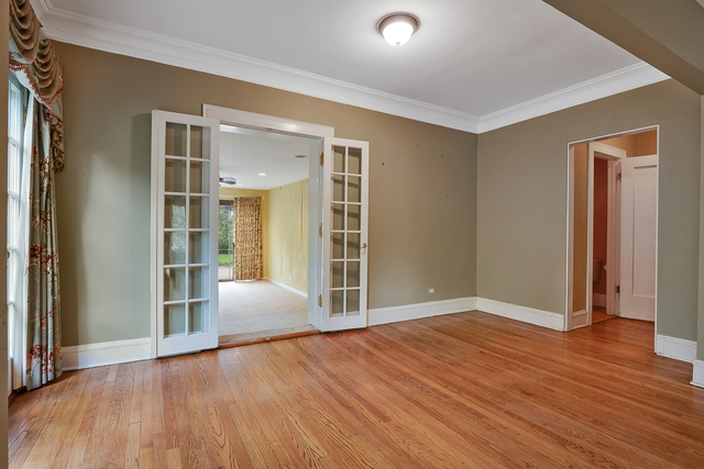 60 Sheridan Road Highland Park, IL 60035 - Photo 6 of 29 an empty room with wooden floor and windows