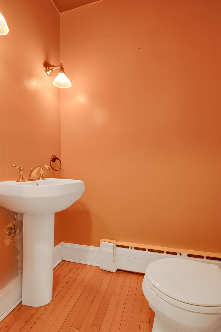 60 Sheridan Road Highland Park, IL 60035 - Photo 8 of 29 a bathroom with a sink a toilet and a mirror