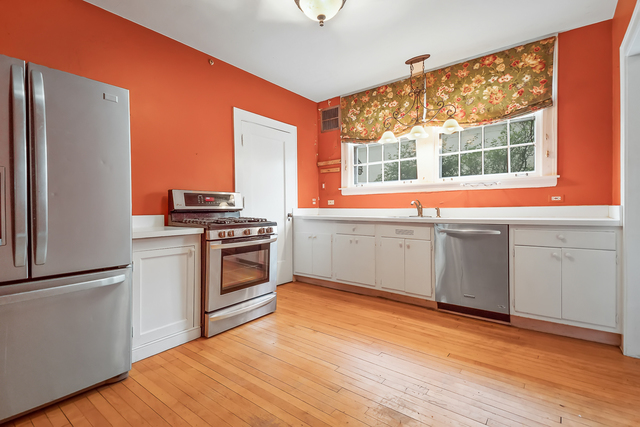 60 Sheridan Road Highland Park, IL 60035 - Photo 9 of 29 a kitchen with stainless steel appliances a stove top oven and a refrigerator