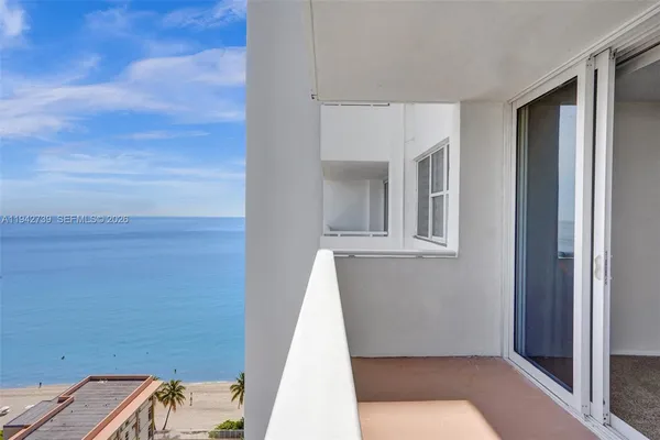 a view of a balcony with an ocean view