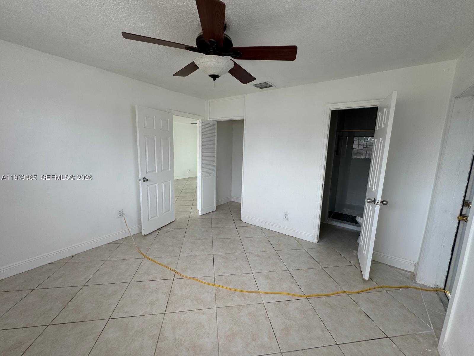 3340 Southwest 94th Place, Unit 1 Miami, FL 33165 - Photo 11 of 21 a view of an empty room with a fireplace