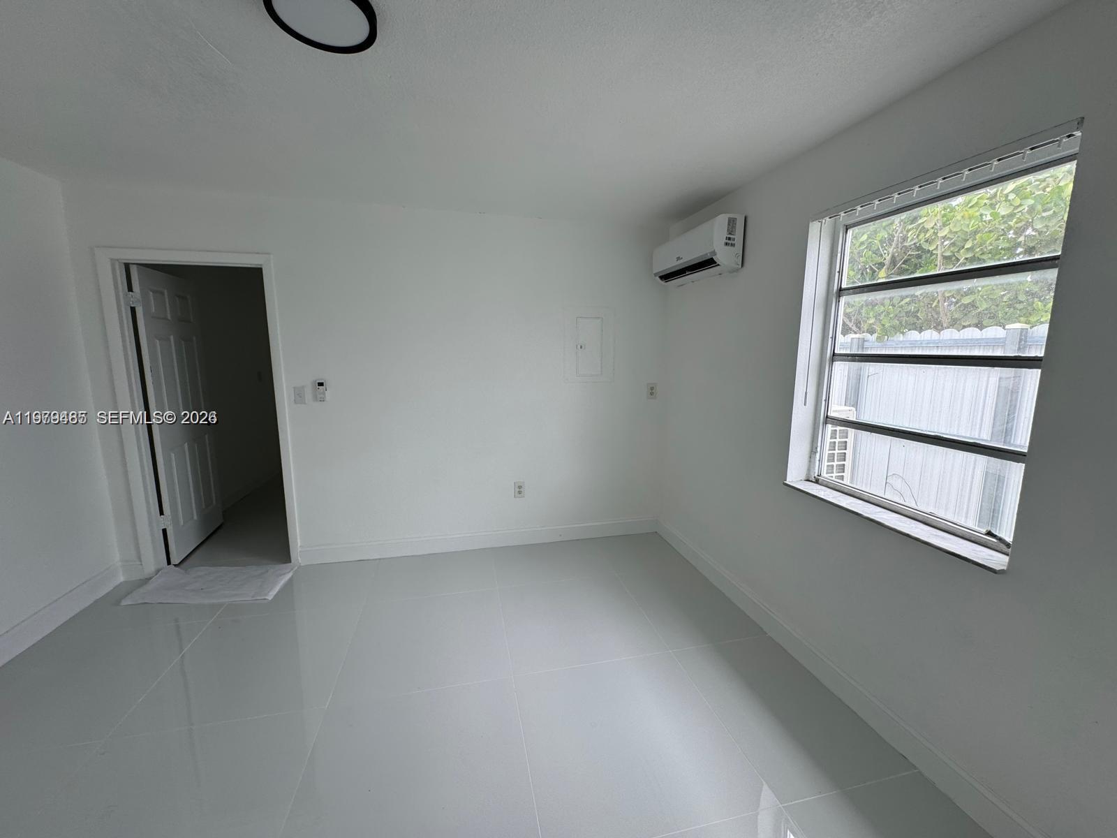 3340 Southwest 94th Place, Unit 1 Miami, FL 33165 - Photo 15 of 21 an empty room with windows and closet