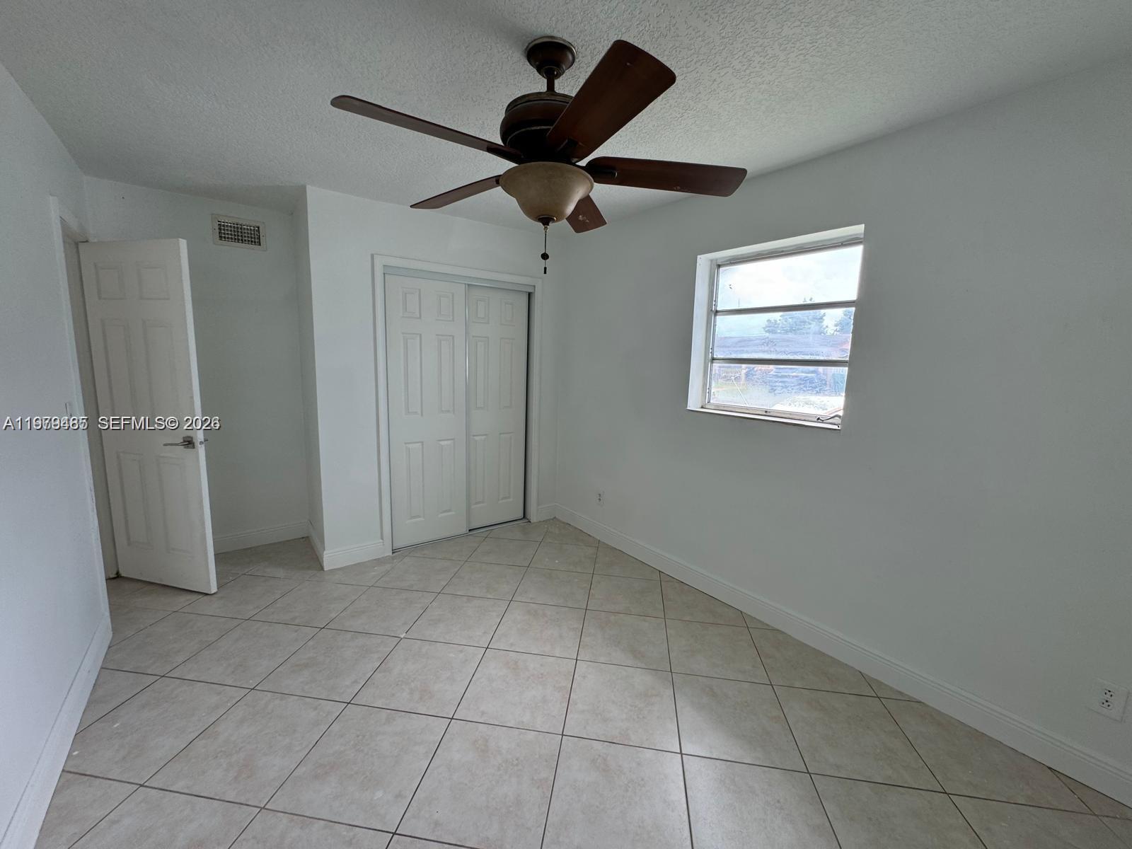 3340 Southwest 94th Place, Unit 1 Miami, FL 33165 - Photo 16 of 21 a view of an empty room with a window
