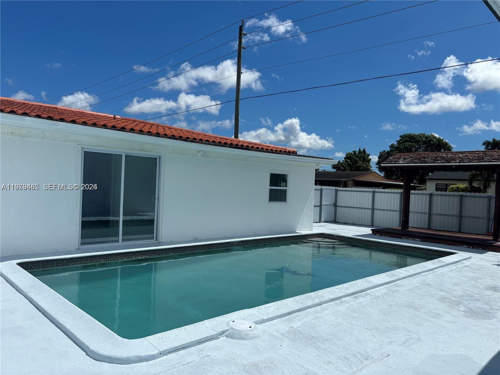 3340 Southwest 94th Place, Unit 1 Miami, FL 33165 - Photo 21 of 21 a backyard of a house with table and chairs