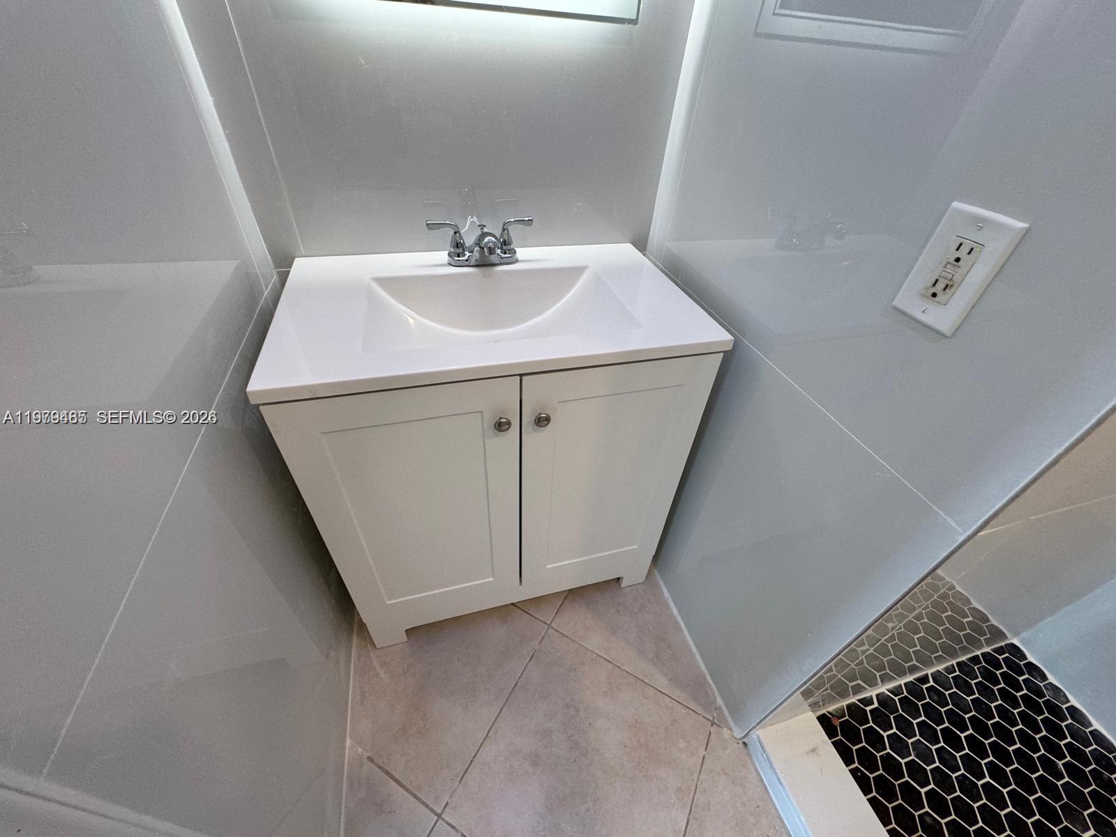 3340 Southwest 94th Place, Unit 1 Miami, FL 33165 - Photo 8 of 21 a bathroom with a sink and vanity