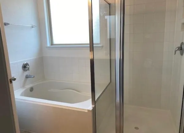 a white bath tub sitting next to a window