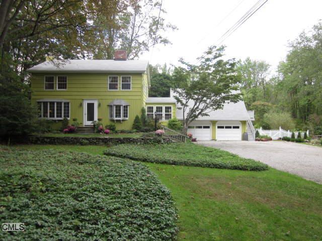 284 Cedar Road Fairfield, CT 06890 - Photo 1 of 1 a front view of a house with a yard and green space