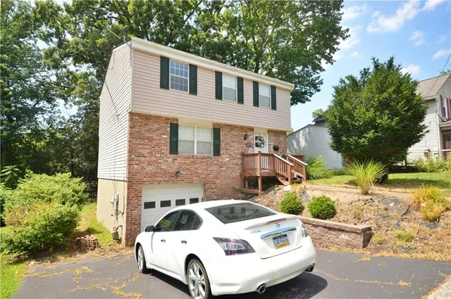 a car parked in front of white house