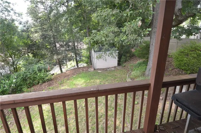 a view of a wooden deck and a forest