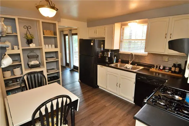 a kitchen with a table chairs refrigerator and cabinets