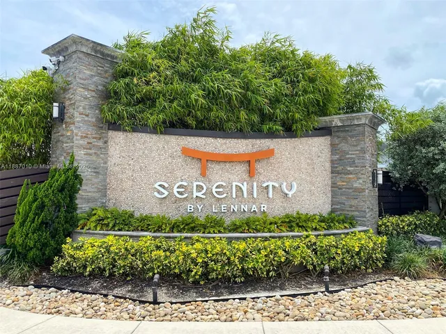 a front view of a house with a garden and yard