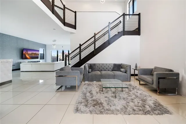 a living room with furniture and a large window